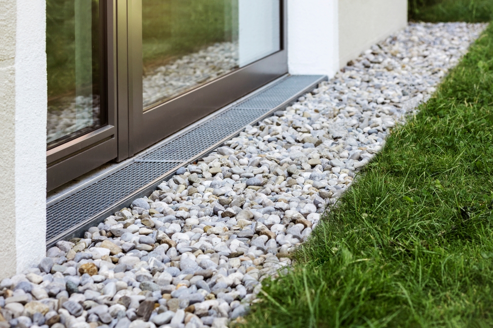 Drain,rock,drainage,stones,of,french,drain,around,building,with